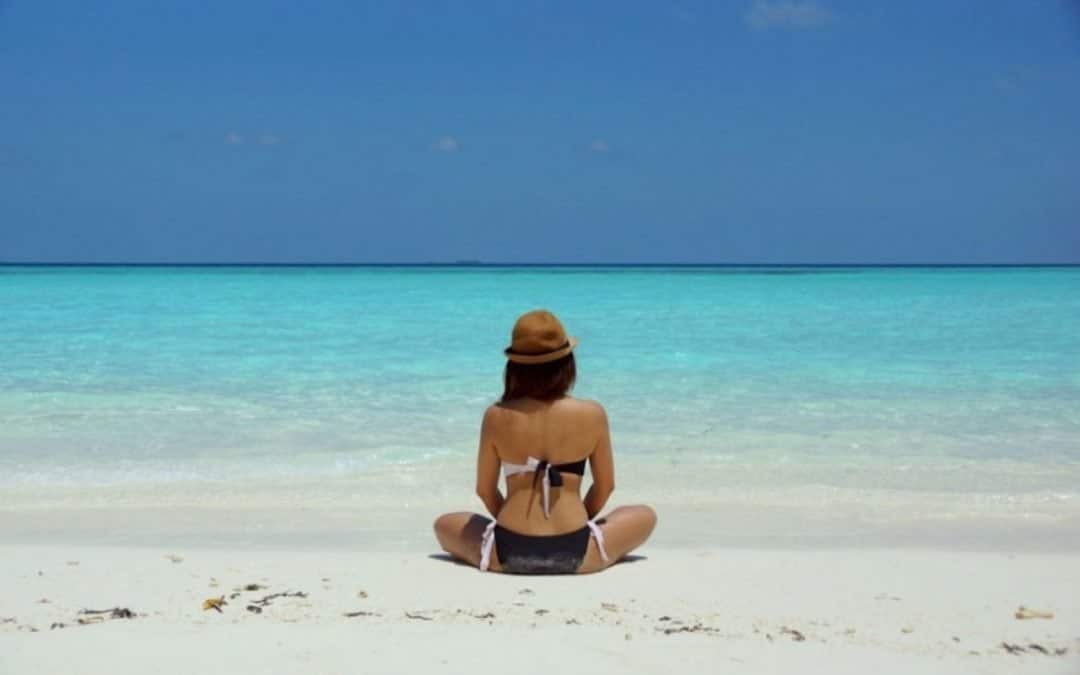 A Woman Seating at the Beach | MUM CFOS